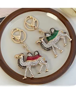 Close-up of crystal-encrusted camel keychains with colorful enamel saddle details
