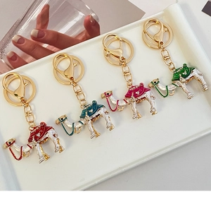 Detailed macro view of four colorful enamel camel keychains with rhinestones and gold ring