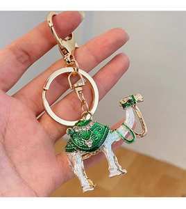 Detailed close-up of camel keychain with green enamel and sparkling rhinestones
