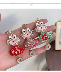 Macro shot of frog keychains with sparkling rhinestones and Chinese wealth characters