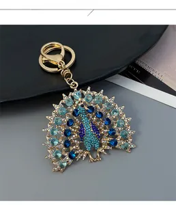Detail of crystal peacock keychain with blue rhinestones and gold lobster clasp