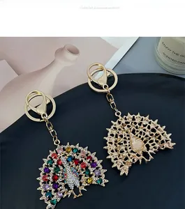 Detailed front and back view of crystal peacock keychain with colorful rhinestones