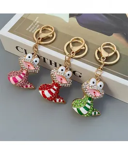 Détail de porte-clés grenouille en strass colorés en rose, rouge et vert avec clips dorés