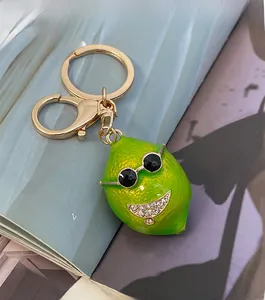 Detailed view of creative green lemon keychain with sunglasses and lobster clasp