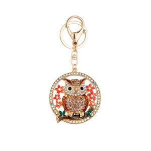 Porte-clés chouette doré exquis avec strass en cristal et fleurs rouges sur fond blanc