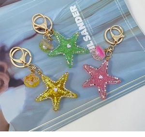 Detailed view of colorful rhinestone starfish keychains with glitter and shells