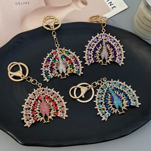 Peacock rhinestone car keychain set in gold metal with four colorful diamond finishes
