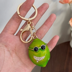 Cute green lemon keychain with sunglasses and crystal rhinestones on a gold metal ring