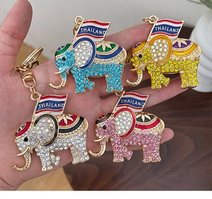 Detailed close-up of elephant keychains featuring sparkling rhinestones and Thailand flag