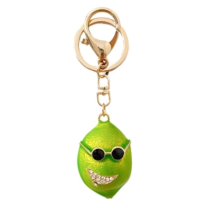 Creative green lemon keychain with sunglasses and sparkling smile on white background