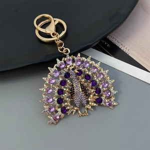 Golden peacock keychain with purple rhinestones for women's bags and purses