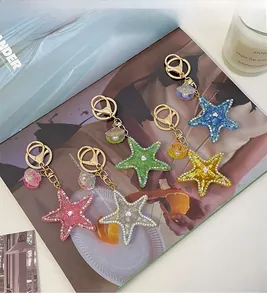 Detail of colorful starfish and shell keychains decorated with rhinestones and glitters