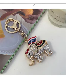 Detailed macro view of crystal elephant keychain with Thailand flag and gold lobster clasp