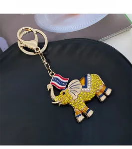 Detail of Thai elephant keychain with yellow rhinestones and gold-plated finish
