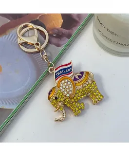 Detail of a golden elephant keychain with sparkling rhinestones and Thailand flag charm
