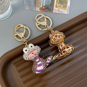 Porte-clés serpent créatif avec strass violets et blancs sur base en métal doré