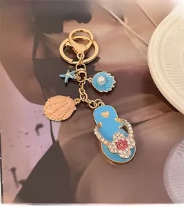 Detail of beach-themed keychain featuring blue flip-flop with rhinestones and starfish