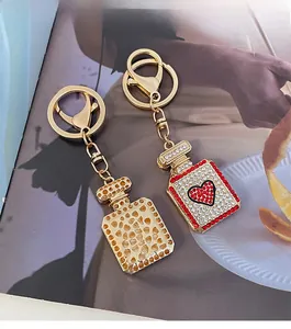 Detail of heart perfume bottle keychain with red and white sparkling rhinestones