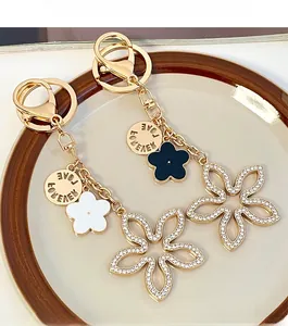 Detail of clover keychain with white rhinestones and Love Forever gold engraving
