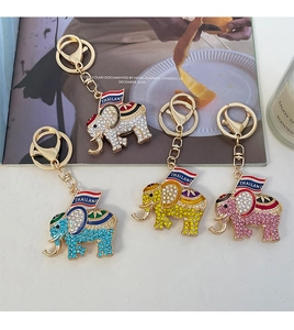 Detail view of sparkling rhinestone elephant keychains in four colors with gold alloy base