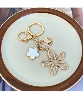 Detail of lucky four-leaf clover keychain with rhinestones and Love Forever engraving