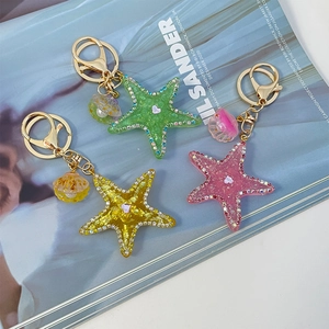 Sparkly starfish and shell keychains with rhinestones in green yellow and pink
