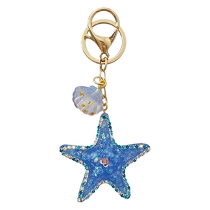 Diamond-encrusted blue starfish and shell keychain with sparkling crystals and gold ring