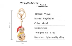 Detail view of a gold Christmas penguin keychain with rhinestones and size dimensions