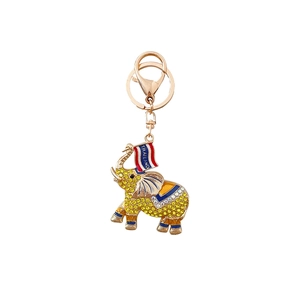 Sparkling elephant keychain with yellow rhinestones and Thailand flag charm on white background