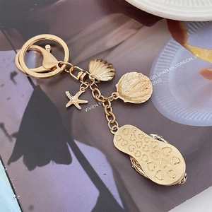 Golden alloy keychain with sea shells, starfish and heart pattern flip flop charms