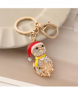 Detailed view of a gold Christmas penguin keychain with sparkling white rhinestones