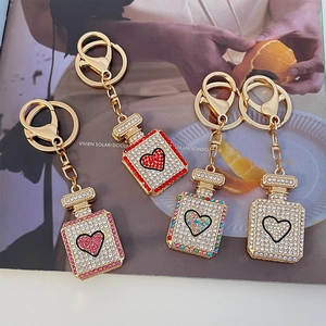 Sparkling rhinestone perfume bottle keychain set with heart motif in four assorted colors