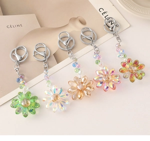 Detailed macro view of crystal sunflower keychains in five gradient colors with metal clasps