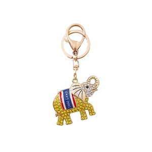 Porte-clés éléphant thaïlandais brillant avec strass jaunes et texte sur métal doré