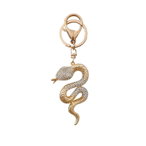 Porte-clés serpent doré avec strass scintillants et fermoir mousqueton sur fond blanc
