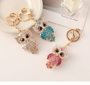 Detailed view of three owl keychains with colorful rhinestones and gold alloy clips