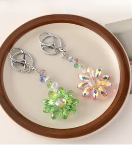 Macro detail of colorful crystal sunflower keychains with silver metal lobster clasps