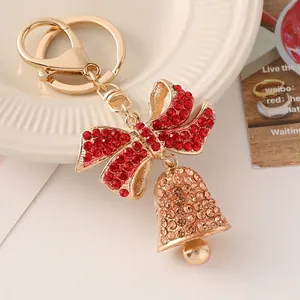 Golden Christmas bell keychain with red rhinestone bow and sparkling crystals decoration