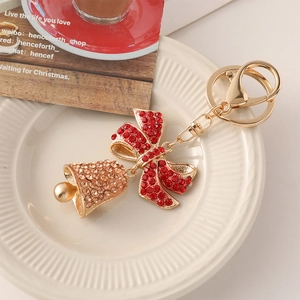Sparkling Christmas bell keychain with rhinestones and red bow on golden base