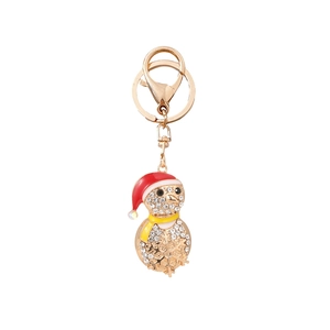 Sparkly penguin Christmas keychain with white rhinestones and red hat on gold alloy