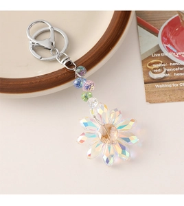 Detail of multi-faceted crystal sunflower keychain with colorful beaded accents and silver ring