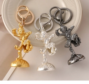 Detailed view of Sun Wukong metal keychains in gold, matte silver and gun black finishes