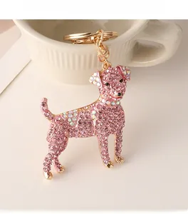 Macro shot of a sparkling pink rhinestone dog keychain with golden hardware detail