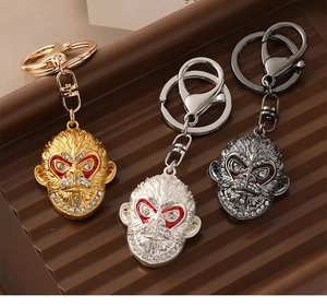 Detailed view of three monkey king keychains in gold, silver and grey finishes