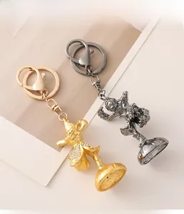 Detailed macro view of gold and gunmetal monkey keychains with sparkling rhinestones