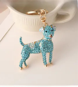 Detail view of the dog keychain featuring vibrant blue rhinestones and gold metal lobster clasp