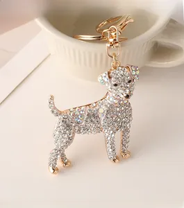 Detail of a sparkling crystal-encrusted dog keychain with golden metal ring and swivel clasp