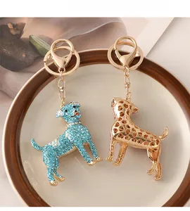 Close-up of blue rhinestone dog keychain and gold hollow heart pattern metal pendant
