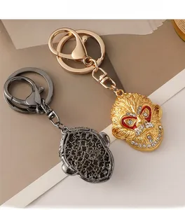 Detailed view of Monkey King keychain showing front crystal inlay and back honeycomb hollow structure
