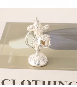 Detailed silver Sun Wukong keychain with sparkling rhinestones on a minimalist magazine
